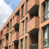 View of brick multifamily housing complex.