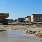 View of lot with half-constructed homes.