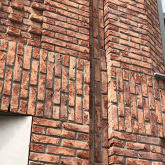 Side of brick building with window.
