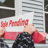 Sale pending sign in front of home.