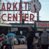 Crowd walking in public market in Seattle.