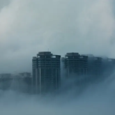 Illustration of a city shrouded in air pollution/clouds