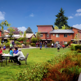 Courtyard with groups of  families playing, and sititing