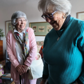 Two older adults in a room