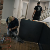 Repairman working on cabinetry