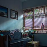 Darkened apartment with shades down.