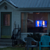 House with presidential debate seen through living room window