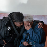 Woman being comforted by a friend.