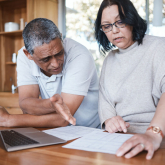 Couple reviewing financial documents.