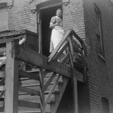 Woman on stairs of a Chicago apartment, 1941.