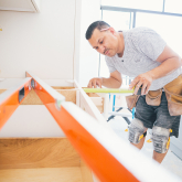 Contractor measuring kitchen counters for a remodeling project