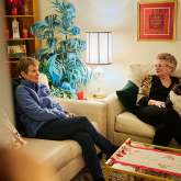 Two older adult women in their living room.