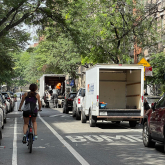 Moving trucks on a city street.