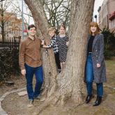 Family standing outside their home.
