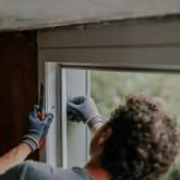Person repairing a window.
