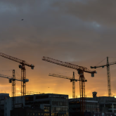 Cranes above apartment buildings under construction.