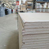 A stack of drywall in a home improvement store