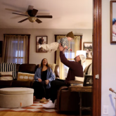 Parents with their baby in their living room.