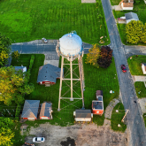 Aerial view of a water tower in a rural community.