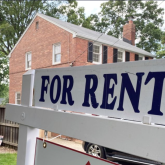 For rent sign in front of a house.