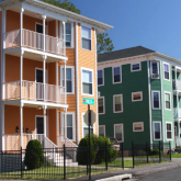 A street lined with triple deckers in Worcester, MA.