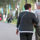 Older adult couple walking in a park.