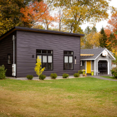 ADU with adjacent garage in a backyard.