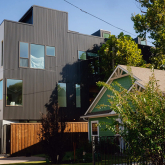 Modern multifamily next to an older single family home.