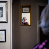 A woman and her reflection in a mirror.