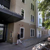 Person walking into public housing building