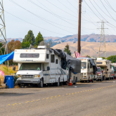 A row of RVs along the side of a road.