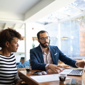 A couple reviewing options with their financial advisor.