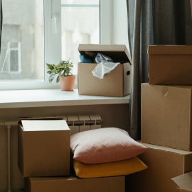 Moving boxes stacked by apartment window.