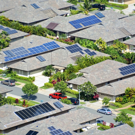 Neighborhood of ranch homes with solar panels.