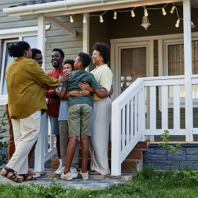 Family assembled on front steps of home.