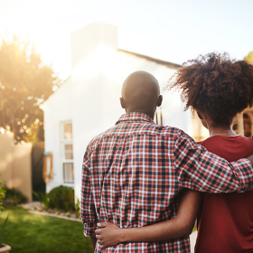 Black couple looking at a house