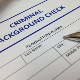 Criminal background check document with a pen