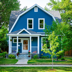 View of a small home with yard.