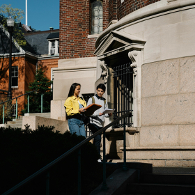 Two students walking on campus