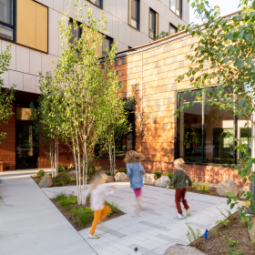 Children playing in the courtyard of a multifamily building.