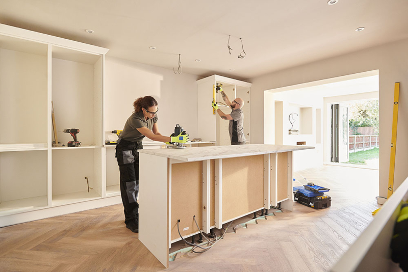 Two contractors working on a kitchen renovation