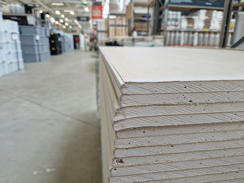 A stack of drywall in a home improvement store