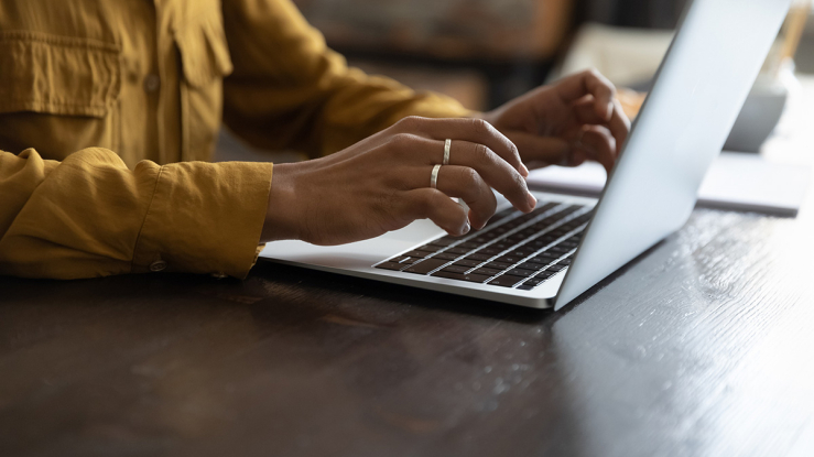 Person typing on a laptop.