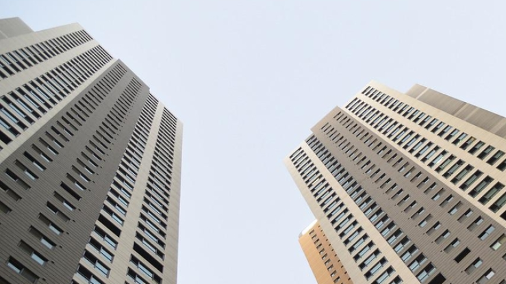 Looking up at skyscrapers.