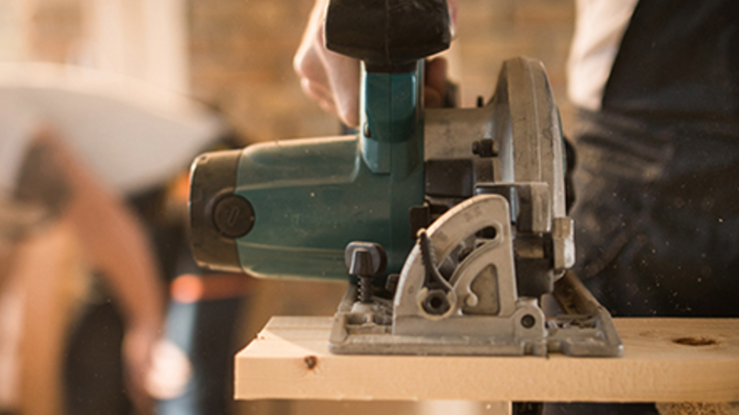 Person using a saw.