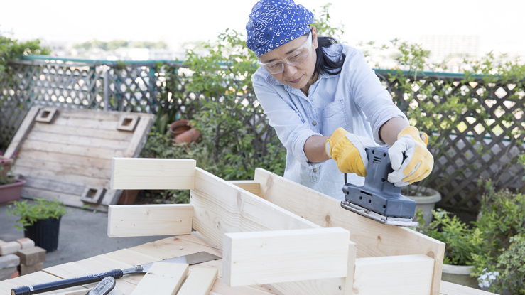 Woman building a wooden bench