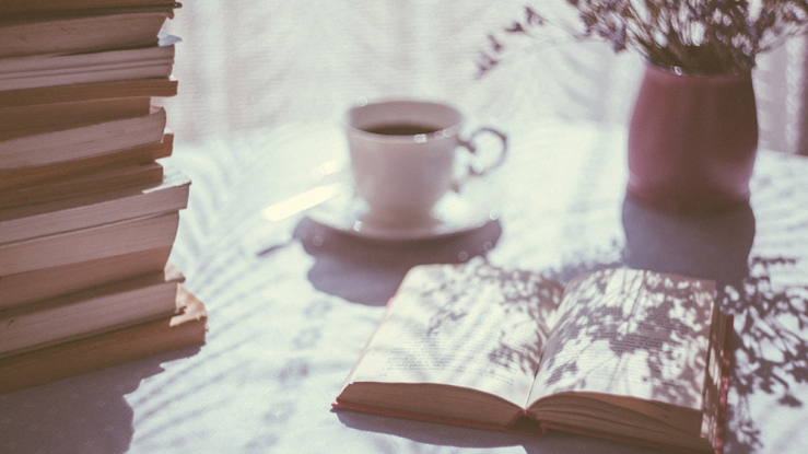 Sunny desk with open book.