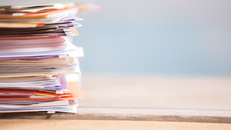 Stack of papers on desk.