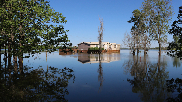 A small house surrounded by floodwater.