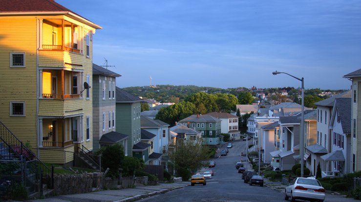 Residential street with triple decker housing.